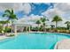 Stunning community pool area featuring a cabana, lounge chairs, and beautifully landscaped surroundings at 3639 Santa Caterina Blvd, Lakewood Ranch, FL 34211