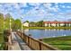 Scenic view of the lake from a wooden pier, with ducks swimming and birds perched on the railing at 4005 Crockers Lake Blvd # 26, Sarasota, FL 34238