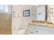 Bathroom with vanity, granite countertop, glass shelves, and tiled glass-door shower at 4101 4Th Ave, Holmes Beach, FL 34217