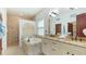 Bathroom featuring a double vanity, soaking tub and glass enclosed shower at 4101 4Th Ave, Holmes Beach, FL 34217