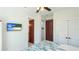 Bright bedroom with a ceiling fan, TV, and closet with stylish louvered doors at 4101 4Th Ave, Holmes Beach, FL 34217