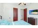 Bedroom with a ceiling fan, TV, closet, and doorways to other rooms at 4101 4Th Ave, Holmes Beach, FL 34217
