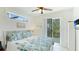 Bright bedroom featuring ceiling fan, and balcony access, and white walls and trim, creates a serene retreat at 4101 4Th Ave, Holmes Beach, FL 34217