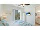 Serene bedroom with soft lighting, balcony access, and en-suite bathroom, offers a tranquil retreat at 4101 4Th Ave, Holmes Beach, FL 34217