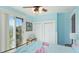 Comfortable bedroom with balcony access offering views, closet, ceiling fan and bright interior at 4101 4Th Ave, Holmes Beach, FL 34217