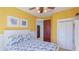 Warm bedroom featuring closet, ceiling fan, and balcony access, creates a welcoming retreat for homeowners at 4101 4Th Ave, Holmes Beach, FL 34217