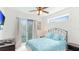 Bright bedroom with sliding glass doors to a balcony, complemented by a ceiling fan at 4101 4Th Ave, Holmes Beach, FL 34217