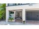 Inviting covered entrance with brick pavers and a gray double door, leading into a meticulously landscaped home at 4101 4Th Ave, Holmes Beach, FL 34217