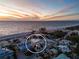 Aerial view of beachfront homes near the ocean with circle, stunning sunset background at 412 S Casey Key Rd, Nokomis, FL 34275