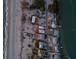 Aerial view of coastal homes nestled between a sandy beach and a serene waterway, capturing the essence of waterfront living at 412 S Casey Key Rd, Nokomis, FL 34275
