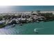 Aerial view of island homes and turquoise ocean by the beach with circling at 412 S Casey Key Rd, Nokomis, FL 34275