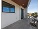 A modern balcony features gray tile flooring and stainless steel railings, providing an open-air space at 412 S Casey Key Rd, Nokomis, FL 34275
