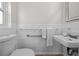 Clean bathroom featuring a toilet, sink, and shower, with classic fixtures, offering a functional and practical space at 412 S Casey Key Rd, Nokomis, FL 34275