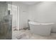 Modern bathroom showcases a sleek, freestanding tub and a separate glass-enclosed shower at 412 S Casey Key Rd, Nokomis, FL 34275