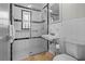Well-maintained bathroom with tiled walls, glass-enclosed shower, and classic fixtures for a clean and functional space at 412 S Casey Key Rd, Nokomis, FL 34275