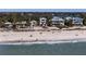Beautiful view of beachfront homes with direct access to the sandy beach and ocean, ideal for seaside living at 412 S Casey Key Rd, Nokomis, FL 34275
