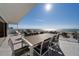 Oceanfront patio with an outdoor dining table and seating, as well as a lounge area with an ocean view at 412 S Casey Key Rd, Nokomis, FL 34275