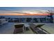 A beachfront patio featuring outdoor lounge furniture provides views of the sandy beach and the sky at sunset at 412 S Casey Key Rd, Nokomis, FL 34275