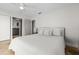 Bedroom with light colored tile floors, ceiling fan, and view into an adjoining bathroom at 412 S Casey Key Rd, Nokomis, FL 34275