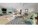 A bright bedroom features stone floors, patterned rug, a comfortable sitting area, and a bed at 412 S Casey Key Rd, Nokomis, FL 34275