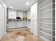 Walk-in closet offering ample storage with built-in shelving, drawers, and hanging rods at 412 S Casey Key Rd, Nokomis, FL 34275