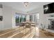 Charming dining area with backyard view, a stylish chandelier, and comfortable seating for memorable meals at 412 S Casey Key Rd, Nokomis, FL 34275