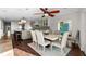 Bright dining area with modern table and chairs, open to the kitchen and living space at 412 S Casey Key Rd, Nokomis, FL 34275
