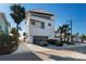 Exterior of a modern three-story home with a two-car garage and palm trees at 412 S Casey Key Rd, Nokomis, FL 34275