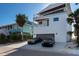 Exterior of a modern three-story home with balconies and a two-car garage at 412 S Casey Key Rd, Nokomis, FL 34275