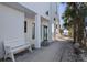 Modern house exterior shows covered patio with bench, columns and beach access at 412 S Casey Key Rd, Nokomis, FL 34275