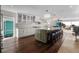 Bright kitchen boasts an island with seating, stone countertops, and views of the ocean at 412 S Casey Key Rd, Nokomis, FL 34275