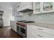 Kitchen featuring white cabinets and stainless steel appliances including a Wolf range at 412 S Casey Key Rd, Nokomis, FL 34275