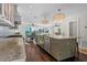 Bright kitchen with stone counters, stainless appliances, and eat in dining area at 412 S Casey Key Rd, Nokomis, FL 34275