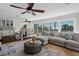 Inviting living space with large windows, comfortable sectional sofa, and access to the outdoor balcony at 412 S Casey Key Rd, Nokomis, FL 34275