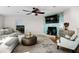 Cozy living room with patterned tile wall, fireplace, comfortable seating, and natural light at 412 S Casey Key Rd, Nokomis, FL 34275