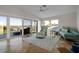 Inviting living room with a neutral rug, comfortable seating, and large sliding glass doors to the exterior at 412 S Casey Key Rd, Nokomis, FL 34275