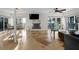 Bright living room with waterfront view, fireplace, and tile flooring at 412 S Casey Key Rd, Nokomis, FL 34275