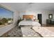 A comfortable main bedroom with a large window offering ample natural light and neighborhood views at 412 S Casey Key Rd, Nokomis, FL 34275