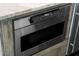 Stainless steel Sharp microwave installed in kitchen island cabinetry, with easy to read control panel at 412 S Casey Key Rd, Nokomis, FL 34275