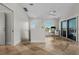 Bright office space with natural light, a modern desk setup, and sliding glass doors to a balcony at 412 S Casey Key Rd, Nokomis, FL 34275