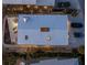 Aerial view of a rooftop featuring skylights, solar panels, and outdoor lounging at 412 S Casey Key Rd, Nokomis, FL 34275