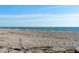 Expansive sandy beach with clear blue ocean views, perfect for leisurely walks and enjoying the coastal breeze at 412 S Casey Key Rd, Nokomis, FL 34275