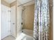 Bathroom featuring a shower-tub combo and tiled walls at 4120 Shamrock Dr, Venice, FL 34293
