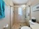 Bathroom with tile shower, glass enclosure, and neutral color scheme at 4120 Shamrock Dr, Venice, FL 34293
