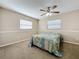 Bedroom with ceiling fan, windows, carpet, and neutral paint scheme at 4120 Shamrock Dr, Venice, FL 34293