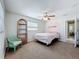 Bright bedroom with a ceiling fan, a large window, and neutral walls at 4120 Shamrock Dr, Venice, FL 34293