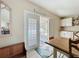 Dining area with table and chairs and double doors leading to the screened patio at 4120 Shamrock Dr, Venice, FL 34293