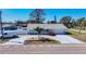 This aerial exterior view highlights the property's manicured lawn and concrete driveway at 4120 Shamrock Dr, Venice, FL 34293