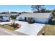 Inviting single-story home featuring a spacious driveway, lush lawn, and mature landscaping at 4120 Shamrock Dr, Venice, FL 34293