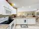 Bright kitchen with granite counters, tiled floor, and open to the adjacent living area at 4120 Shamrock Dr, Venice, FL 34293